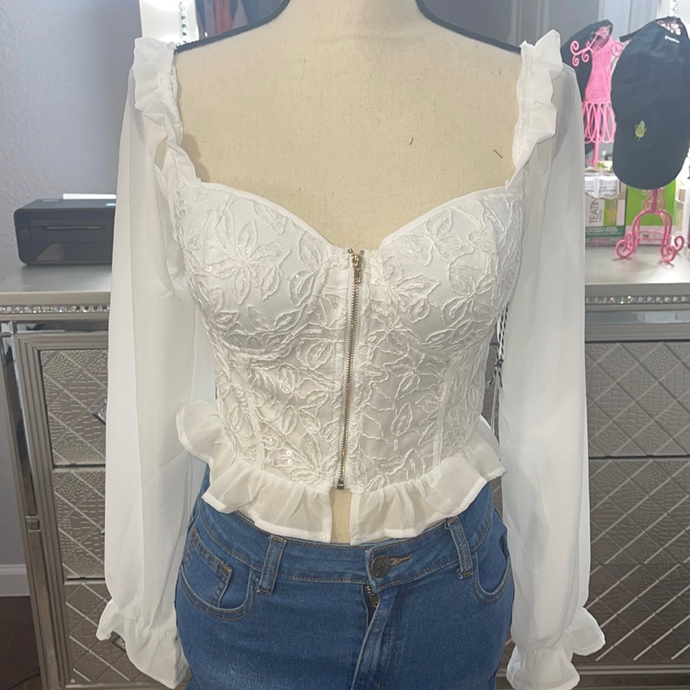 Story on long sleeve white crop top